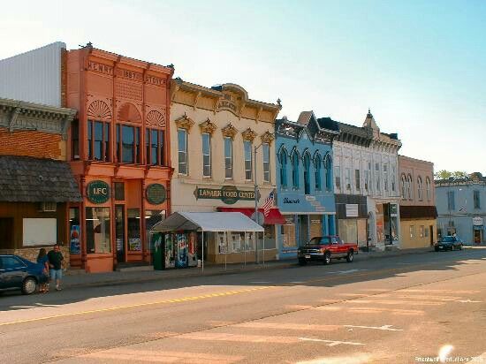 A view of the city street with colorful storefronts.