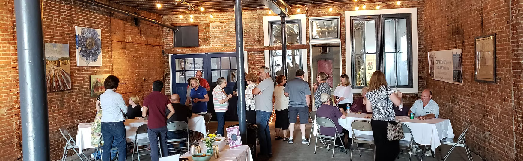People gathered inside a brick building.